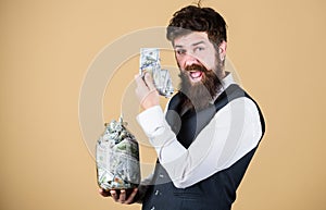 Man bearded guy hold jar full of cash savings. Safe place to keep money. Personal accountant. Businessman with his