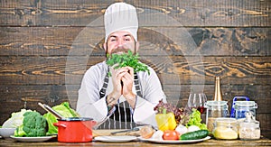 Man bearded hipster cooking fresh vegetables. Culinary recipe concept. Freshest possible ingredients. Chef use fresh