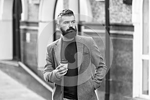 Man bearded hipster drinking coffee paper cup. One more sip of coffee. Drinking coffee on the go. Businessman