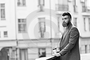 Man bearded hipster drinking coffee paper cup. One more sip of coffee. Enjoying coffee on the go. Businessman well