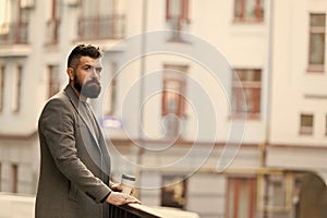 Man bearded hipster drinking coffee paper cup. One more sip of coffee. Enjoying coffee on the go. Businessman well