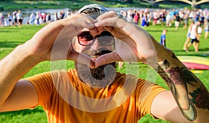 Man bearded hipster in front of crowd people show heart gesture riverside background. Cheerful fan love summer fest
