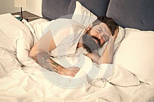 Man bearded hipster having problems with sleep. Guy lying in bed try to relax and fall asleep. Relaxation techniques