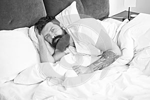 Man bearded hipster having problems with sleep. Guy lying in bed try to relax and fall asleep. Relaxation techniques