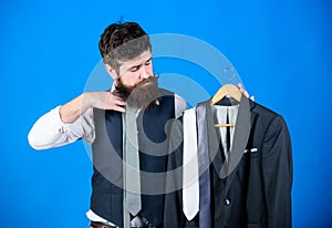 Man bearded hipster hold neckties and formal suit. Perfect necktie. Shopping concept. Stylist advice. Difficulty