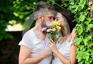 Man bearded hipster kisses girlfriend. Secret romantic kiss. Moment of intimacy. Couple love romantic date nature