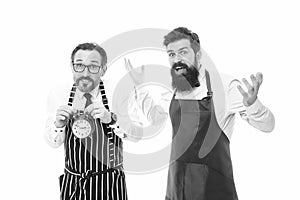 Man bearded hipster and mature chef apron white background. Working hours and lunch break. Lack of time. Check what time