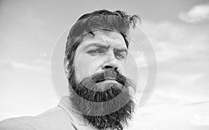 Man bearded hipster with mustache blue sky background. Expert tips for growing and maintaining mustache. Hipster serious