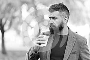 Man bearded hipster prefer coffee take away. Businessman drink coffee outdoors. Reloading energy. Relaxing coffee break