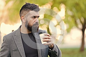 Man bearded hipster prefer coffee take away. Businessman drink coffee outdoors. Reloading energy. Relaxing coffee break