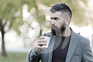 Man bearded hipster prefer coffee take away. Businessman drink coffee outdoors. Reloading energy. Relaxing coffee break