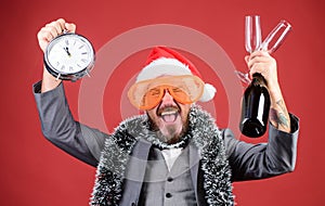 Man bearded hipster santa hold bottle. Corporate christmas party. Lets celebrate winter holiday. Boss santa hat