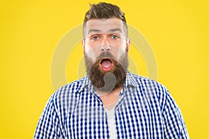 Man bearded hipster with sneezing face open eyes close up yellow background. Brutal hipster sneezing. Allergy concept