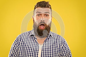 Man bearded hipster with sneezing face open eyes close up yellow background. Brutal hipster sneezing. Allergy concept