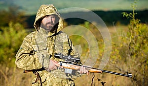 Man bearded hunter with rifle nature background. Experience and practice lends success hunting. How turn hunting into