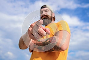 Man bearded muscular brutal hipster outdoors sky background. Masculinity and brutality. Lumbersexual tattooed well