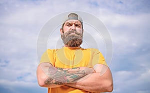 Man bearded muscular brutal hipster outdoors sky background. Masculinity and brutality. Lumbersexual tattooed well