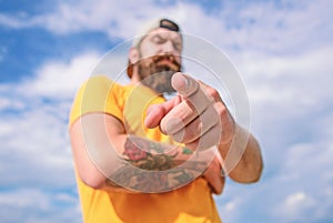 Man bearded muscular brutal hipster outdoors sky background. Masculinity and brutality. Lumbersexual tattooed well