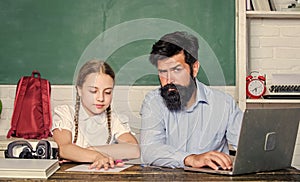Man bearded pedagogue teaching informatics. Study online. Homeschooling with father. Find buddy to help you study