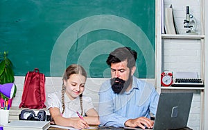 Man bearded pedagogue teaching informatics. Study online. Private lesson. School teacher and schoolgirl with laptop