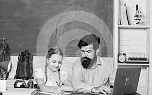 Man bearded pedagogue teaching informatics. Study online. Private lesson. School teacher and schoolgirl with laptop