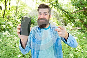 Man bearded wanderer walking in forest with navigation application. Hiking with navigation app. Route for exciting