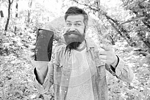 Man bearded wanderer walking in forest with navigation application. Hiking with navigation app. Route for exciting