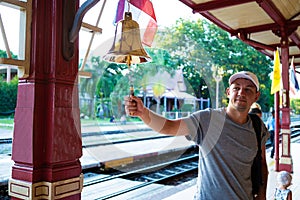 Man beats the bell at the station Hua hin, Thailand