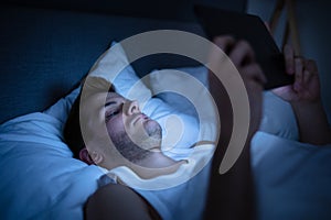 Man In Bed With Digital Tablet