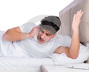 Man in bed suffering from insomnia