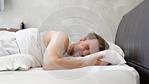 Man in bed suffering insomnia and sleep disorder. Lack of sleep