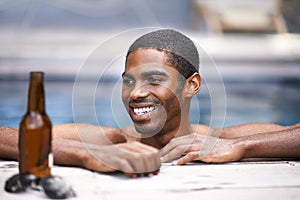 Man, beer and relax poolside, happy and swimming on weekend for wellness on summer holiday. Black male person, luxury