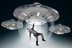 Man being abducted by UFO - alien abduction concept