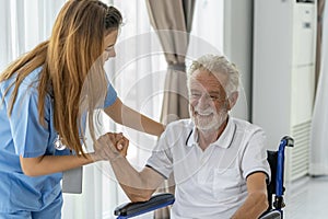 Man being cared for by a private Asian nurse at home suffering from Alzheimer's disease closely care for elderly patients