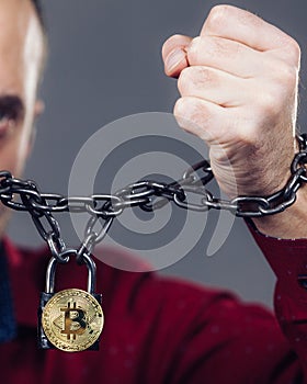 Man being tied up in block chain