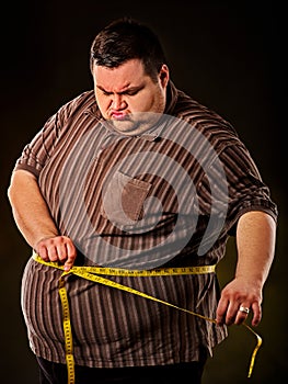 Man belly fat with tape measure weight loss around body .