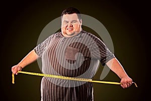 Man belly fat with tape measure weight loss around body .
