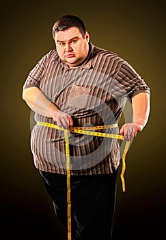 Man belly fat with tape measure weight loss around body .