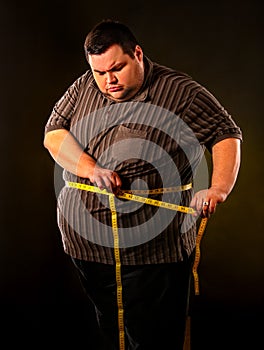 Man belly fat with tape measure weight loss around body .