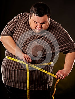 Man belly fat with tape measure weight loss around body .