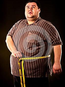 Man belly fat with tape measure weight loss around body .