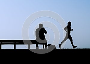 Man on bench watches jogger