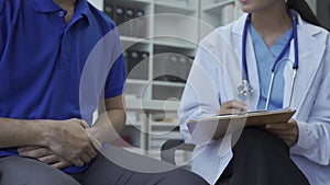 Man with benign prostatic hyperplasia being examined and consulting Asian female doctor