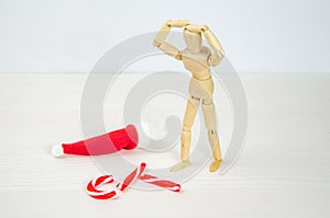 man bent over broken Candy cane in despair. Preparation for Christmas, stress, frustration, failure