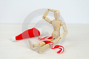 man bent over broken Candy cane in despair. Preparation for Christmas, stress, frustration, failure