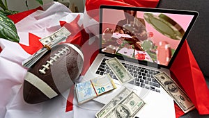 Man betting on sports using laptop at table, closeup. Bookmaker website on screen