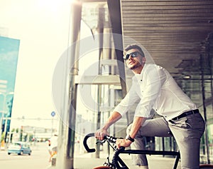 Man with bicycle and headphones on city street