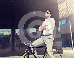 Man with bicycle and headphones on city street