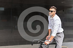 Man with bicycle and headphones on city street