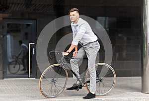 Man with bicycle and headphones on city street